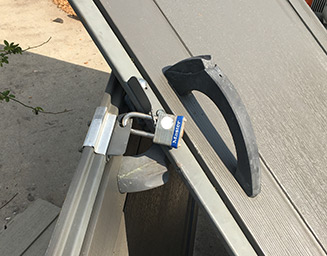 Master Lock lock securing a twisted set of doors